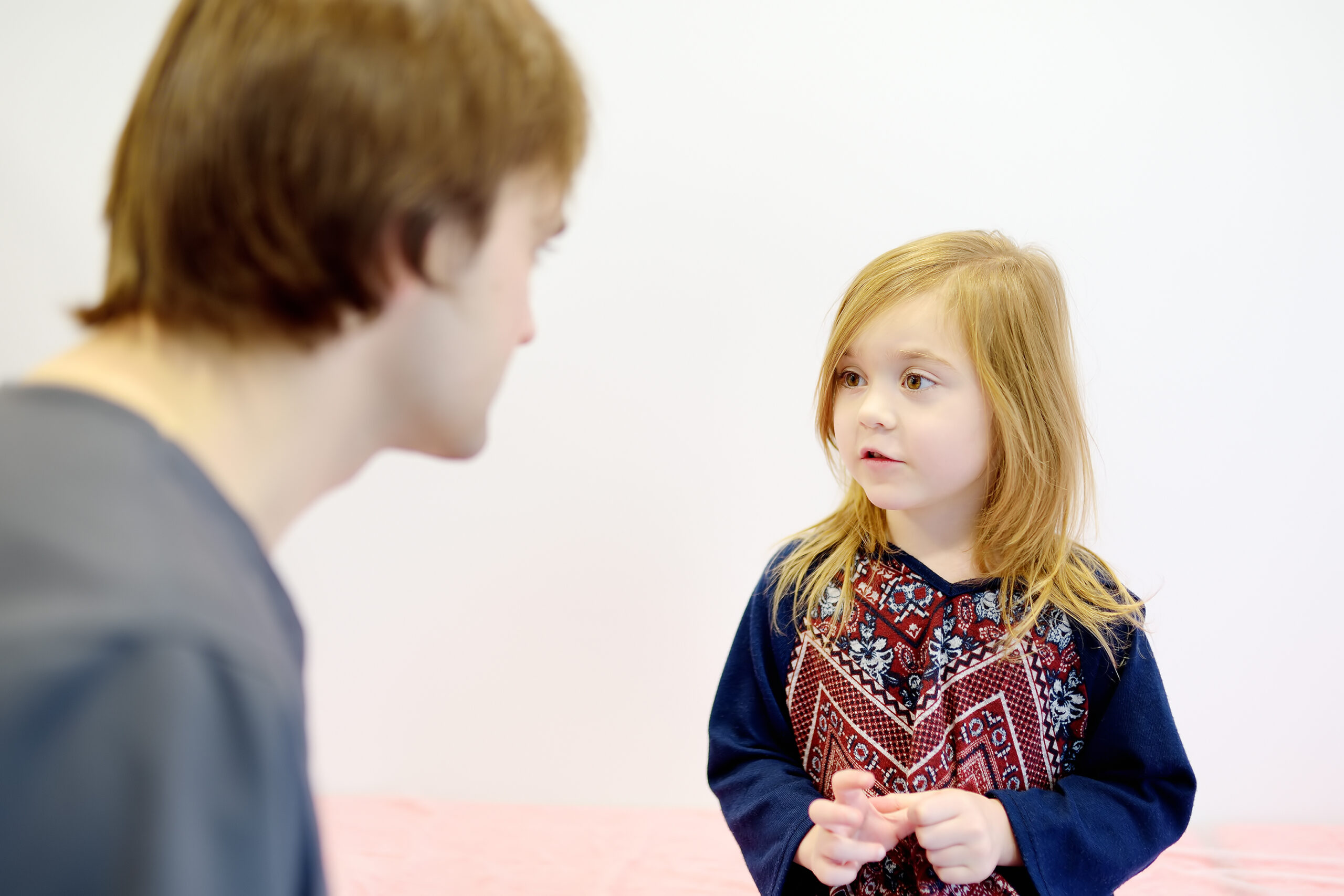 A cute girl is at an appointment with a caring pediatrician. The doctor establishes contact and trust with little patient. Viral and bacterial diseases of kids